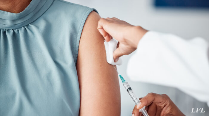 Hands, medical and doctor with patient for vaccine in a clinic for healthcare treatment for prevention. Closeup of a nurse doing a vaccination injection with a needle syringe in a medicare hospital.